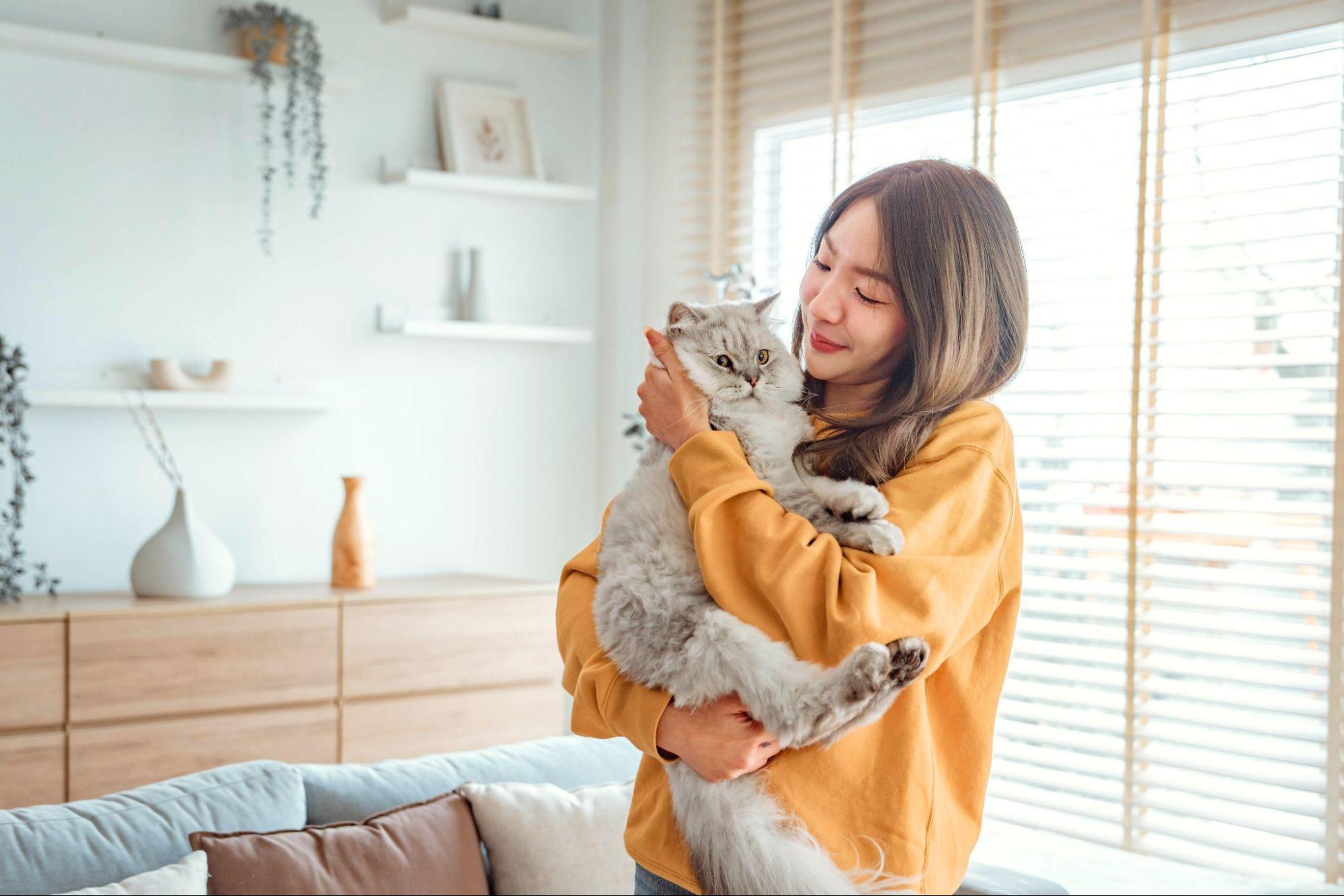 woman hugging a cat