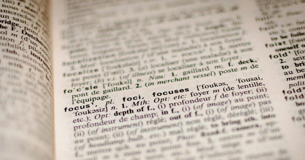 Close-up of an open bilingual dictionary page with the entry for the word focus sharp and the rest blurred